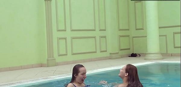 Two hot lesbian brunettes in the swimming pool